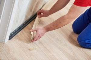 skirting board or baseboard installing. Finishing floor installation