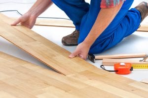 carpenter worker installing laminate flooring in the room